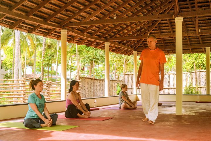 Hari , teacher, founder sharanagati Yogahaus during class with yoga students